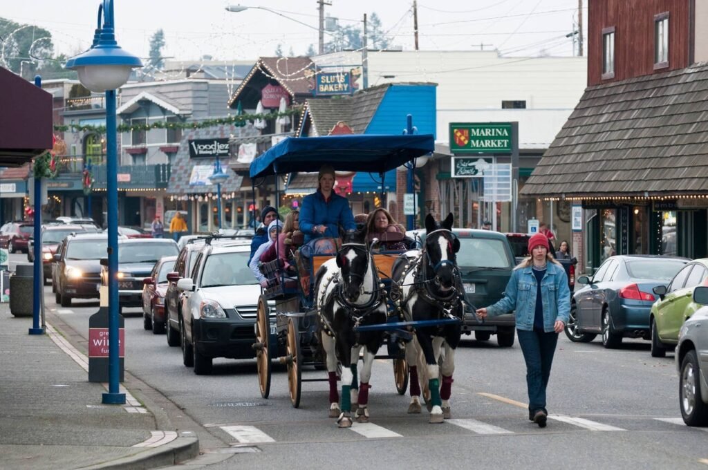 A horse-drawn carriage gives a tour on the main street of Poulsbo, Washington, nicknamed "Little Norway," with its Scandinavian-style buildings in the background.