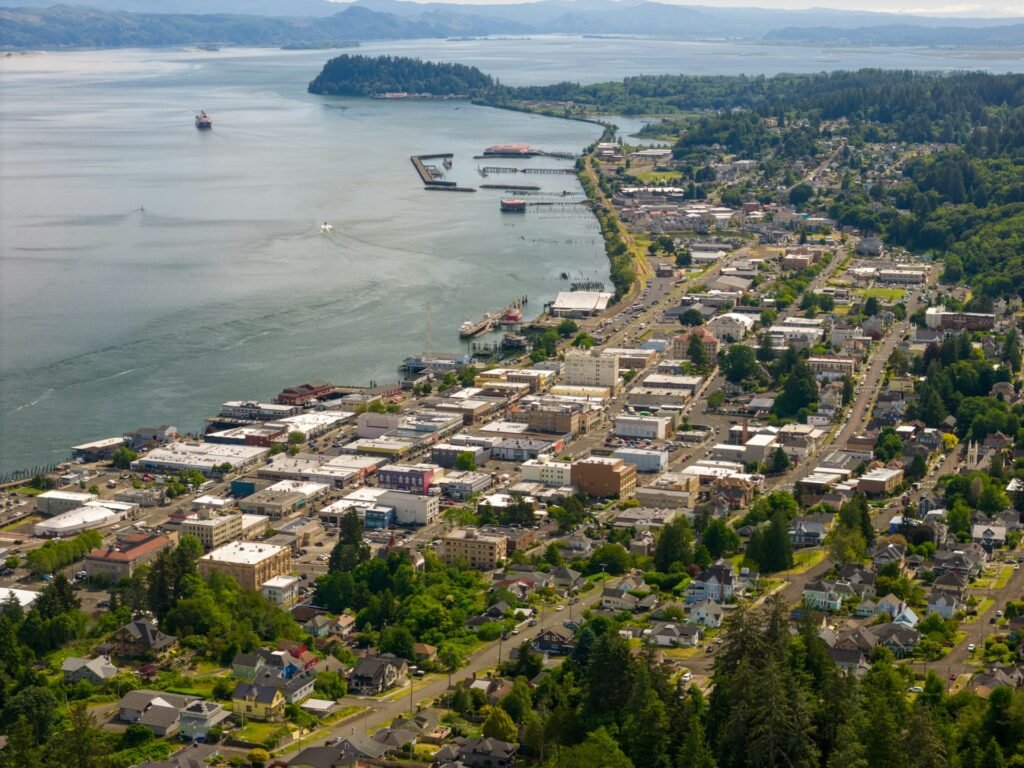 The Columbia River and historic Victorian houses set against the hillside in Astoria, Oregon.