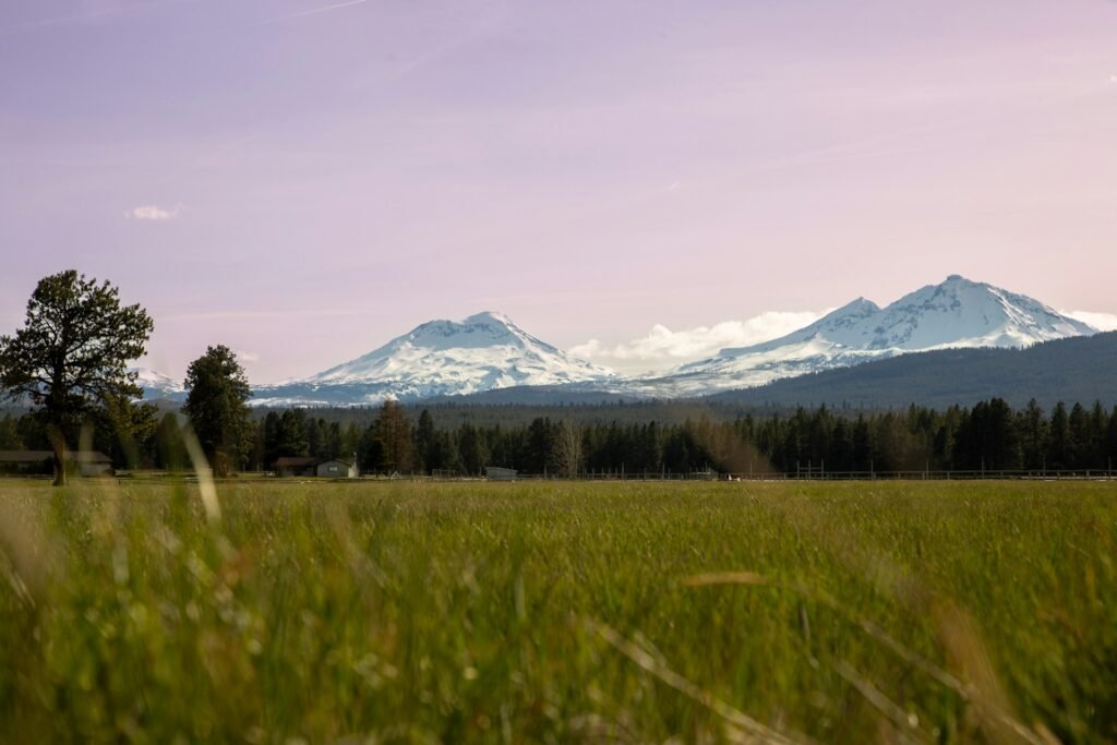 Historic downtown Sisters, Oregon with Three Sisters mountain peaks in the background.
