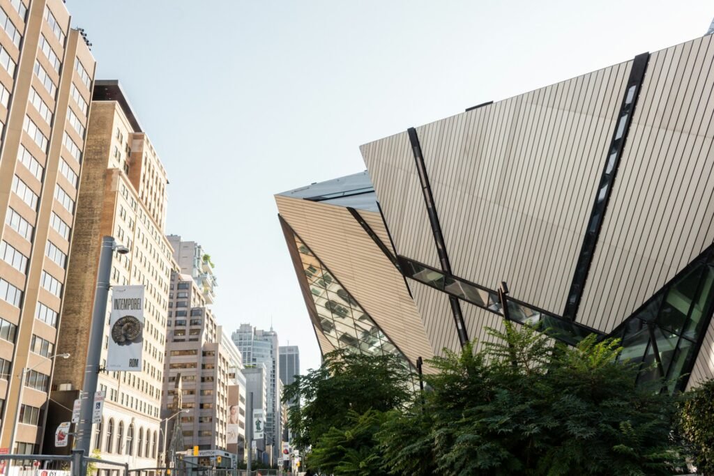 The modern, crystalline architecture of the Royal Ontario Museum (ROM) in Toronto, contrasting with the surrounding city buildings.